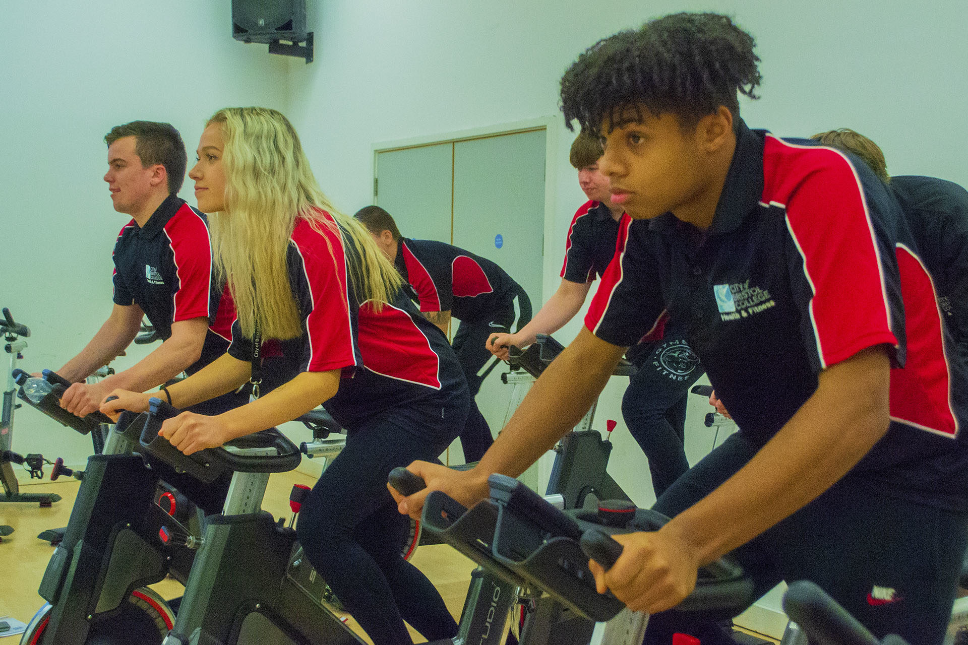 Sports Fitness. Students using training bikes in gym
