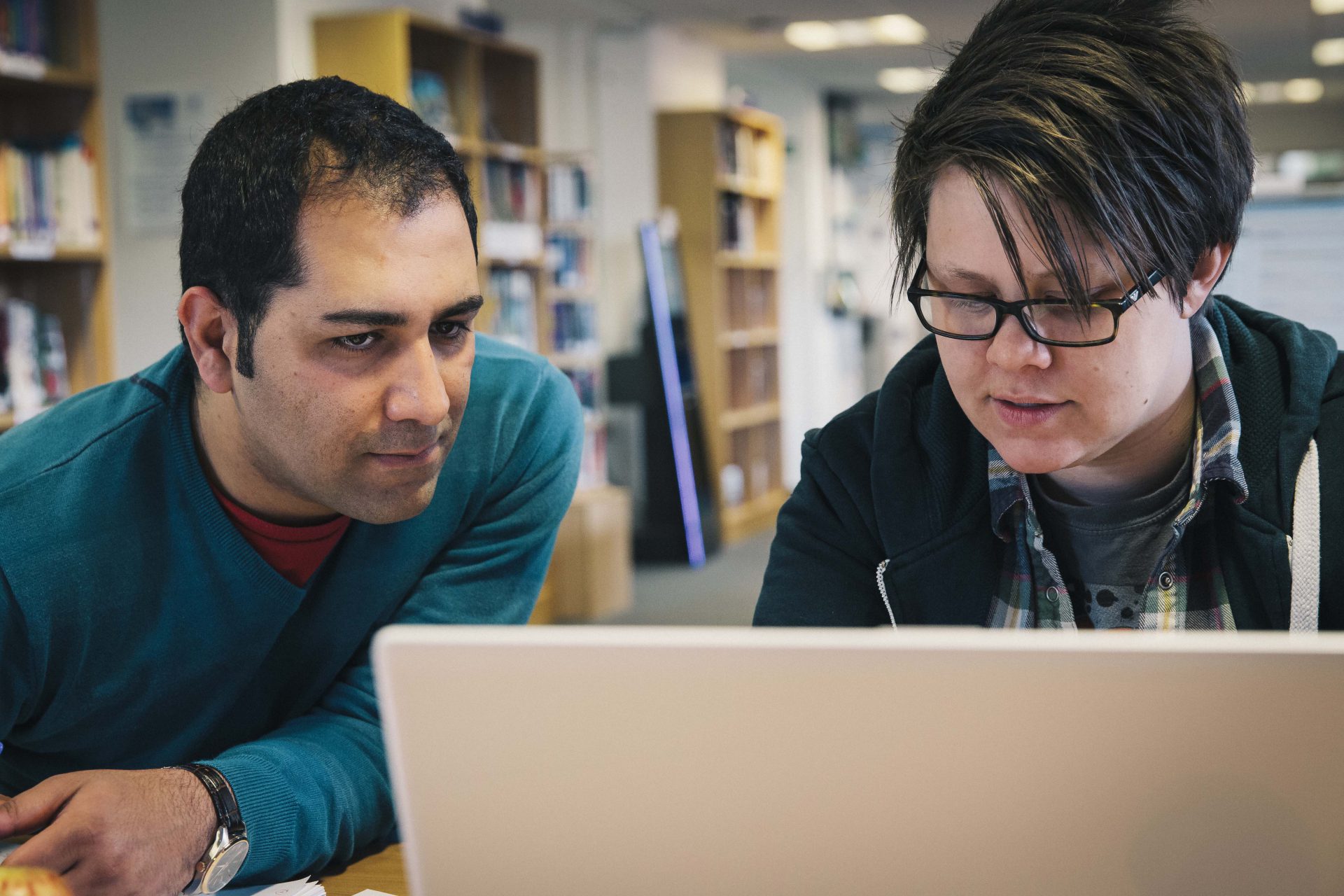Hirad Babakhani and Anna Nicholls work on a laptop in Ashley Down Library