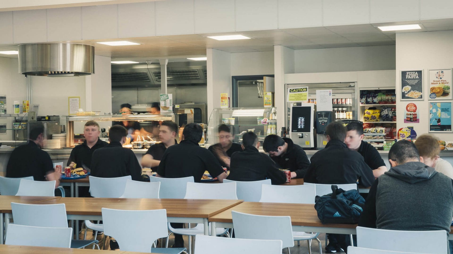 Time-lapsed and blurred image of a cafe, showing the coming and going of students
